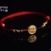Red Tibetan-Style Braided Bracelet with a Golden "Peace and Joy" Charm